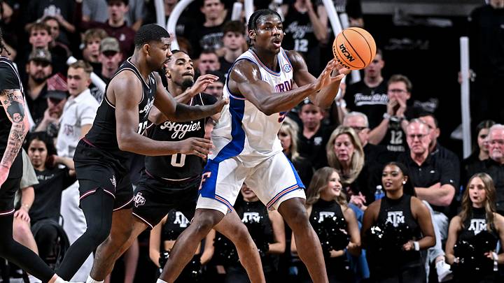 Feb 7, 2026; College Station, Texas, USA; Florida Gators center Rueben Chinyelu (9) passes the ball while being pressured from Texas A&M Aggies during the second half at Reed Arena. Mandatory Credit: Maria Lysaker-Imagn Images