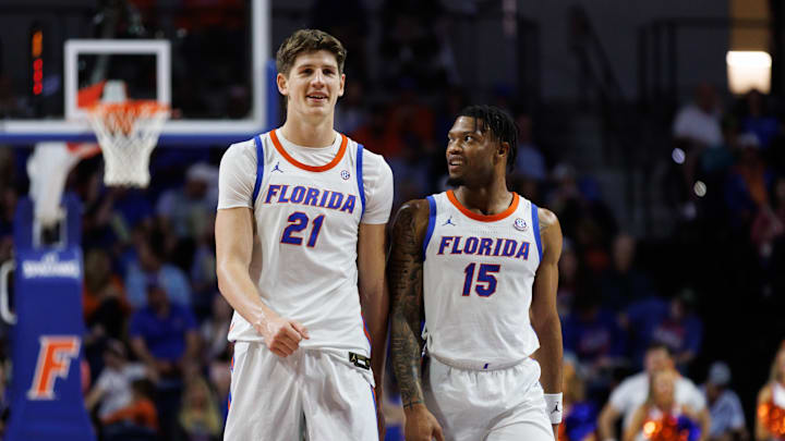 Dec 29, 2024; Gainesville, Florida, USA; Florida Gators forward Alex Condon (21) and Florida Gators guard Alijah Martin (15) smile while walking to position against the Stetson Hatters during the second half at Exactech Arena at the Stephen C. O'Connell Center. Mandatory Credit: Matt Pendleton-Imagn Images