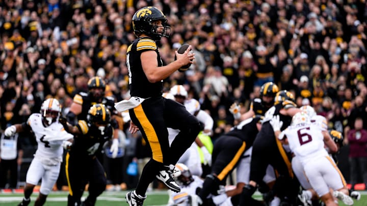 Iowa Hawkeyes quarterback Mark Gronowski (11) skips into the endzone for a touchdown against the Minnesota Golden Gophers Oct. 25, 2025 at Kinnick Stadium in Iowa City, Iowa. Iowa Hawkeyes quarterback Mark Gronowski (11) skips into the endzone for a touchdown against the Minnesota Golden Gophers Oct. 25, 2025 at Kinnick Stadium in Iowa City, Iowa.