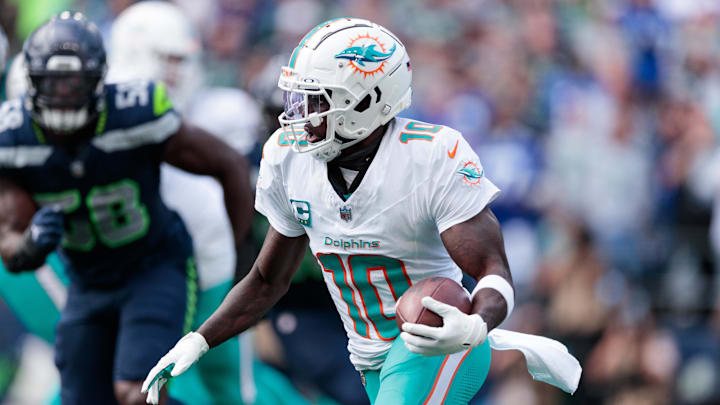 Miami Dolphins wide receiver Tyreek Hill (10) runs with the ball during the third quarter against Seattle Seahawks at Lumen Field. 