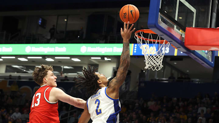 Nov 28, 2025; Pittsburgh, Pennsylvania, USA;  Pittsburgh Panthers forward Cameron Corhen (2) shoots against Ohio State Buckeyes center Christoph Tilly (13) during the first half at the Petersen Events Center. Mandatory Credit: Charles LeClaire-Imagn Images