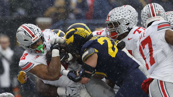 Nov 29, 2025; Ann Arbor, Michigan, USA; Michigan Wolverines linebacker Cole Sullivan (23) tackles Ohio State Buckeyes running back CJ Donaldson Jr. (12) in the second half at Michigan Stadium. Mandatory Credit: Rick Osentoski-Imagn Images