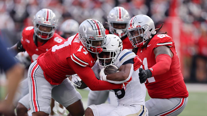 Aug 31, 2024; Columbus, Ohio, USA; Ohio State Buckeyes linebacker Mitchell Melton (17) and defensive tackle Tyleik Williams (91) tackle Akron Zips running back Jordon Simmons (8) during the second half at Ohio Stadium. Mandatory Credit: Joseph Maiorana-Imagn Images