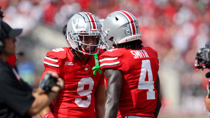 Aug 31, 2024; Columbus, Ohio, USA;  Ohio State Buckeyes wide receiver Jeremiah Smith (4) celebrates with wide receiver Jayden Ballard (9) after scoring a touchdown against the Akron Zips during the first quarter at Ohio Stadium. Mandatory Credit: Joseph Maiorana-Imagn Images
