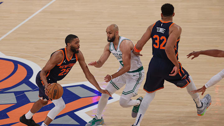 May 12, 2025; New York, New York, USA; New York Knicks forward Mikal Bridges (25) dribbles as Boston Celtics guard Derrick White (9) fights through a screen by New York Knicks center Karl-Anthony Towns (32) in the first half during game four of the second round for the 2025 NBA Playoffs at Madison Square Garden. Mandatory Credit: Vincent Carchietta-Imagn Images