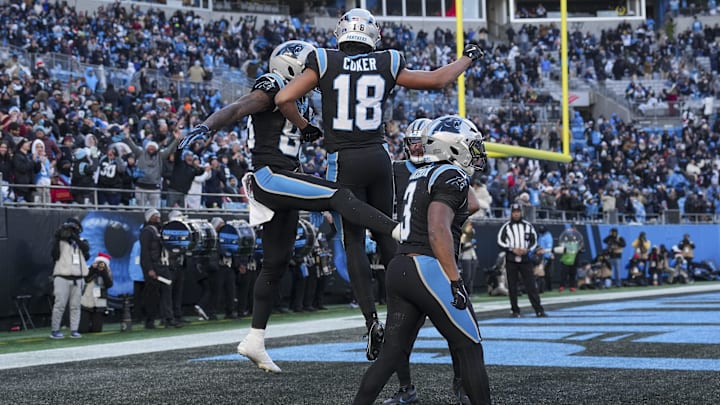 Dec 22, 2024; Charlotte, North Carolina, USA;  Carolina Panthers wide receiver David Moore (83) and wide receiver Jalen Coker (18) celebrate a touchdown against the Arizona Cardinals during the second half at Bank of America Stadium. Mandatory Credit: Jim Dedmon-Imagn Images