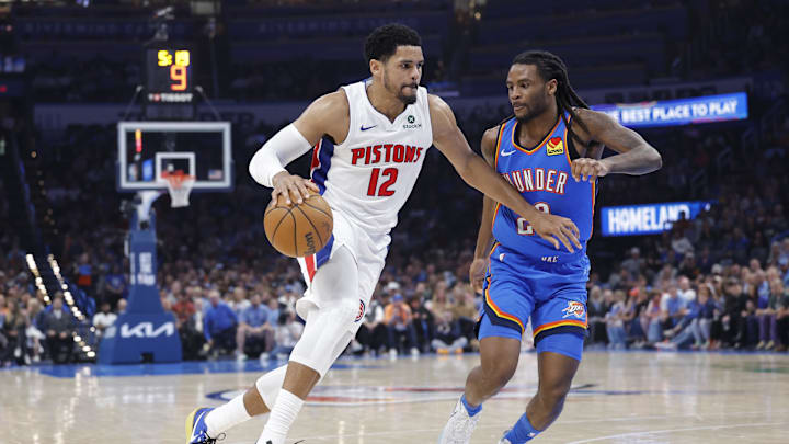Apr 2, 2025; Oklahoma City, Oklahoma, USA; Detroit Pistons forward Tobias Harris (12) drives around Oklahoma City Thunder guard Cason Wallace (22) during the second quarter at Paycom Center. Mandatory Credit: Alonzo Adams-Imagn Images