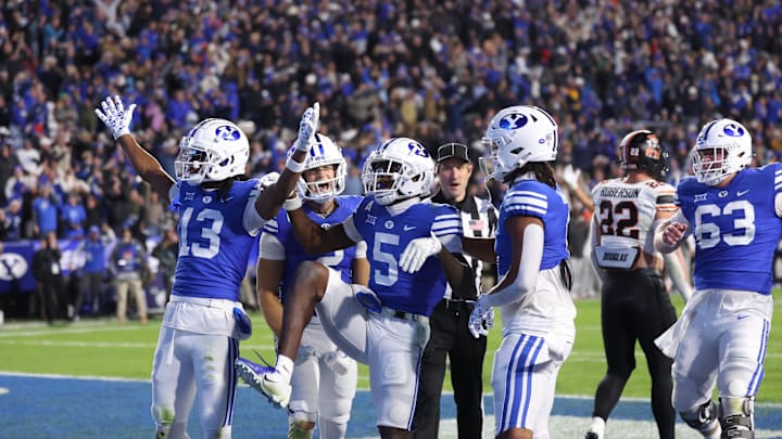 Oct 18, 2024; Provo, Utah, USA; Brigham Young Cougars wide receiver Darius Lassiter (5) celebrates a touchdown with teammates in the last minute of the game against the Oklahoma State Cowboys at LaVell Edwards Stadium. Mandatory Credit: Rob Gray-Imagn Images