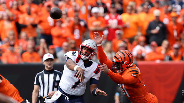 Sep 8, 2024; Cincinnati, Ohio, USA;  New England Patriots quarterback Jacoby Brissett drops to throw as Cincinnati Bengals defensive end Trey Hendrickson (91) applies the pass pressure during the first quarter at Paycor Stadium. Mandatory Credit: Joseph Maiorana-Imagn Images