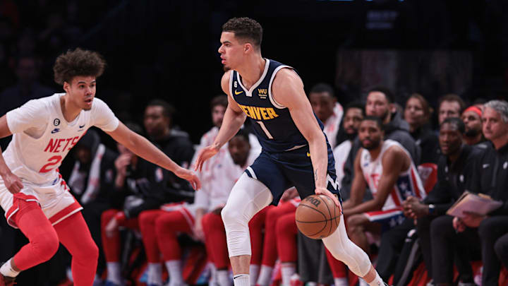Mar 19, 2023; Brooklyn, New York, USA; Denver Nuggets forward Michael Porter Jr. (1) dribbles against Brooklyn Nets forward Cameron Johnson (2) during the second half at Barclays Center. Mandatory Credit: Vincent Carchietta-Imagn Images