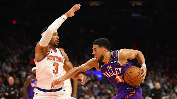 New York Knicks guard Josh Hart defends against Phoenix Suns guard Devin Booker.