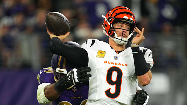 Nov 7, 2024; Baltimore, Maryland, USA; Cincinnati Bengals quarterback Joe Burrow (9) is pressured by Baltimore Ravens linebacker Odafe Oweh (99) during the first quarter at M&T Bank Stadium. Mandatory Credit: Mitch Stringer-Imagn Images