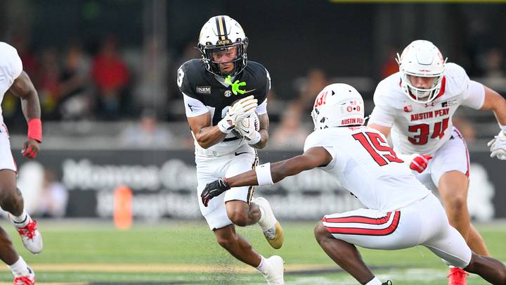 Sep 5, 2026; Nashville, Tennessee, USA;  Vanderbilt Commodores wide receiver Kayleb Barnett (13) runs with the ball against Austin Peay Governors defensive back Tywan Royal (15) during the first half at FirstBank Stadium.  Mandatory Credit: Steve Roberts-Imagn Images