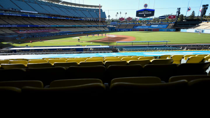 Jul 9, 2020; Los Angeles, California, United States;  The grounds crew works prepares the infield at empty Dodger Stadium before the Dodgers exhibition game against the Arizona Diamondbacks. Mandatory Credit: Robert Hanashiro-USA TODAY Sports