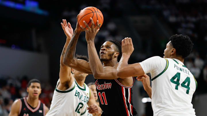 Jan 10, 2026; Waco, Texas, USA; Houston Cougars forward Joseph Tugler (11) drives to the basket between Baylor Bears guard Michael Rataj (12) and center Caden Powell (44) during the first half at Paul and Alejandra Foster Pavilion. Mandatory Credit: Chris Jones-Imagn Images Jan 10, 2026; Waco, Texas, USA; Houston Cougars forward Joseph Tugler (11) drives to the basket between Baylor Bears guard Michael Rataj (12) and center Caden Powell (44) during the first half at Paul and Alejandra Foster Pavilion. Mandatory Credit: Chris Jones-Imagn Images