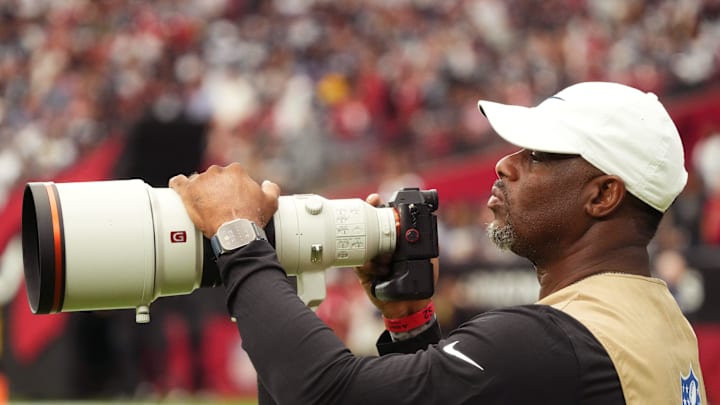 Ken Griffey Jr. takes photos on the sidelines during an Arizona Cardinals game in 2023.