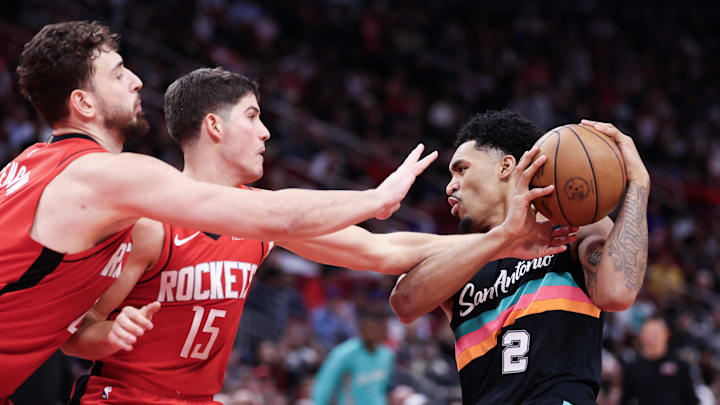 Jan 20, 2026; Houston, Texas, USA;San Antonio Spurs guard Dylan Harper (2) dribbles against Houston Rockets guard Reed Sheppard (15) and center Alperen Sengun (28)  in the second half at Toyota Center. Mandatory Credit: Thomas Shea-Imagn Images