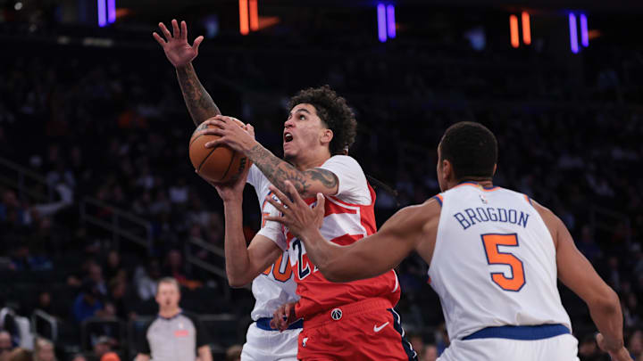 Oct 13, 2025; New York, New York, USA; Washington Wizards forward Will Riley (27) drives to the basket during the second half against New York Knicks guard Malcolm Brogdon (5) at Madison Square Garden. Mandatory Credit: Vincent Carchietta-Imagn Images