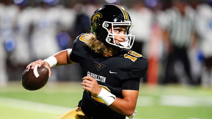 Oct 20, 2023; Carrollton, GA, USA; Carrollton Trojans quarterback Julian Lewis (10) scrambles out of