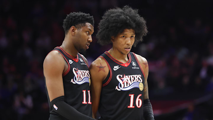 Feb 11, 2026; Philadelphia, Pennsylvania, USA; Philadelphia 76ers forward Justin Edwards (11) and forward Marjon Beauchamp (16) talk during a timeout in the second half against the New York Knicks at Xfinity Mobile Arena. Mandatory Credit: Bill Streicher-Imagn Images