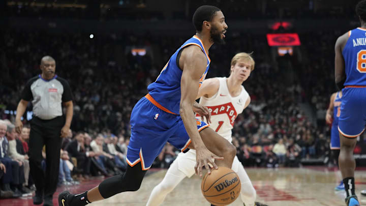 Dec 9, 2024; Toronto, Ontario, CAN; New York Knicks forward Mikal Bridges (25) drives past Toronto Raptors guard Gradey Dick (1) during the first half at Scotiabank Arena. Mandatory Credit: John E. Sokolowski-Imagn Images Dec 9, 2024; Toronto, Ontario, CAN; New York Knicks forward Mikal Bridges (25) drives past Toronto Raptors guard Gradey Dick (1) during the first half at Scotiabank Arena. Mandatory Credit: John E. Sokolowski-Imagn Images