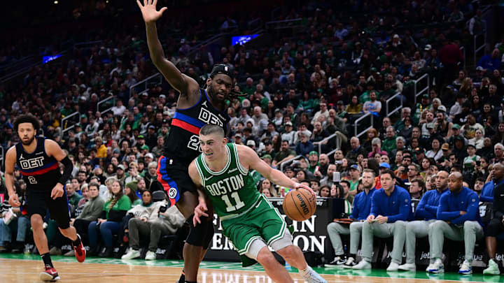 Dec 12, 2024; Boston, Massachusetts, USA;  Boston Celtics guard Payton Pritchard (11) drives to the basket against Detroit Pistons center Isaiah Stewart (28) during the second half at TD Garden. Mandatory Credit: Eric Canha-Imagn Images