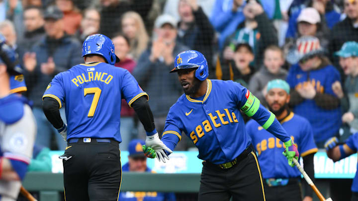 Seattle Mariners designated hitter Jorge Polanco (7) and  left fielder Randy Arozarena (56) celebrate after Polanco hit a home run against the Texas Rangers during the first inning at T-Mobile Park on April 11.