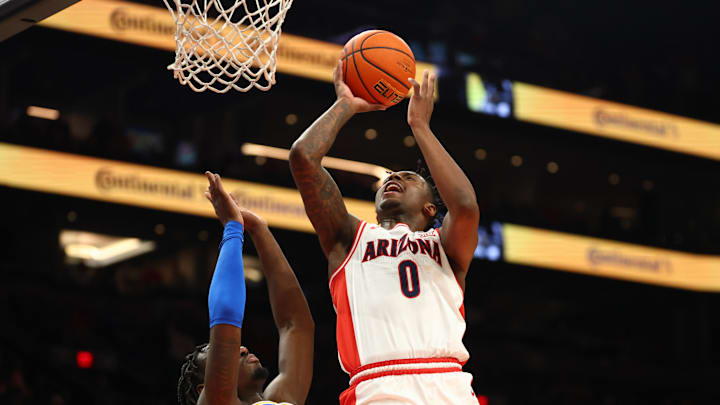 Dec 14, 2024; Phoenix, Arizona, USA; Arizona Wildcats guard Jaden Bradley (0) against the UCLA Bruins in the first half at Footprint Center. Mandatory Credit: Mark J. Rebilas-Imagn Images