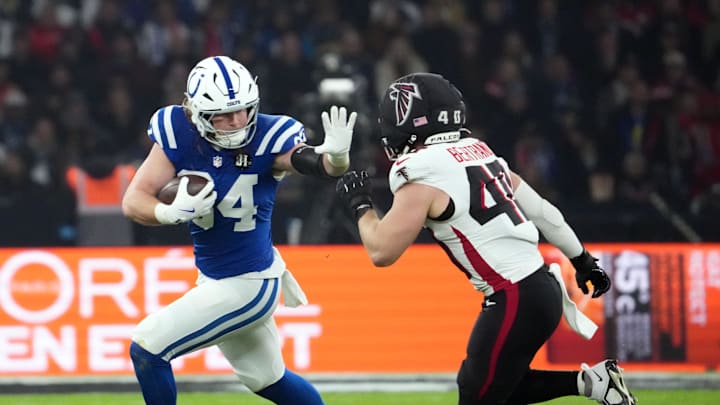 Nov 9, 2025; Berlin, Germany; Indianapolis Colts tight end Tyler Warren (84) runs against Atlanta Falcons linebacker JD Bertrand (40) during the NFL Berlin Game at Olympic Stadium. Mandatory Credit: Kirby Lee-Imagn Images