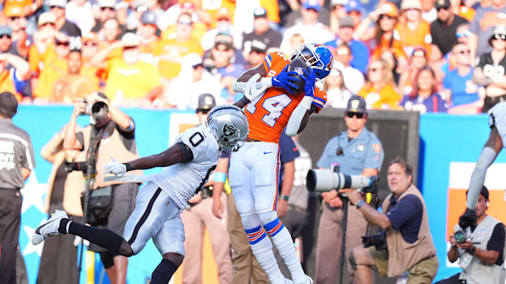 Oct 6, 2024; Denver, Colorado, USA; Denver Broncos wide receiver Courtland Sutton (14) pulls in a reception over Las Vegas Raiders cornerback Jakorian Bennett (0) in the fourth quarter at Empower Field at Mile High. Mandatory Credit: Ron Chenoy-Imagn Images
