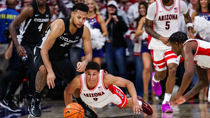 Jan 27, 2025; Tucson, Arizona, USA; Iowa State Cyclones forward Joshua Jefferson (2) and Arizona Wildcats forward Carter Bryant (9) reach for the ball during overtime at McKale Center. Mandatory Credit: Aryanna Frank-Imagn Images