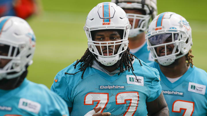 Miami Dolphins defensive tackle John Jenkins (77) runs on the field during minicamp at Baptist Health Training Complex in 2022.\
