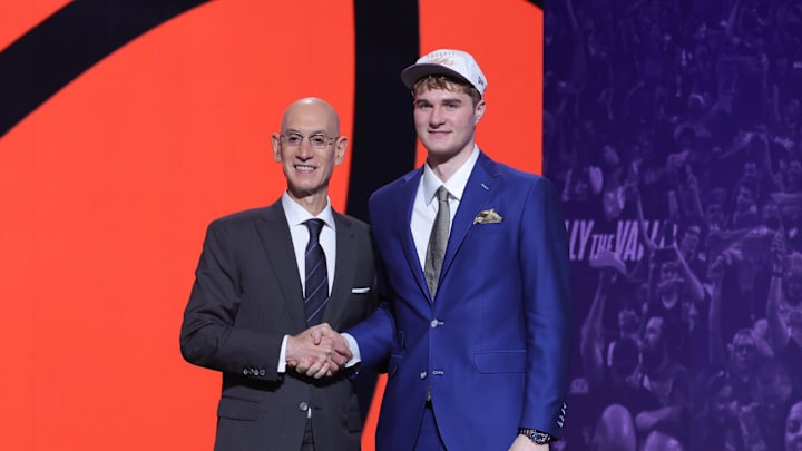 Jun 25, 2025; Brooklyn, NY, USA; Liam McNeeley stands with NBA commissioner Adam Silver after being selected as the 29th pick by the Phoenix Suns in the first round of the 2025 NBA Draft at Barclays Center. Mandatory Credit: Brad Penner-Imagn Images Jun 25, 2025; Brooklyn, NY, USA; Liam McNeeley stands with NBA commissioner Adam Silver after being selected as the 29th pick by the Phoenix Suns in the first round of the 2025 NBA Draft at Barclays Center. Mandatory Credit: Brad Penner-Imagn Images
