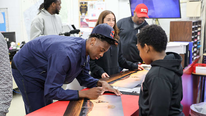 Brockton’s AJ Dybantsa signs autographs for students after declaring for the 2026 NBA Draft at Davis School (K-8) in Brockton, Massachusetts on Thursday, April 23, 2026.
