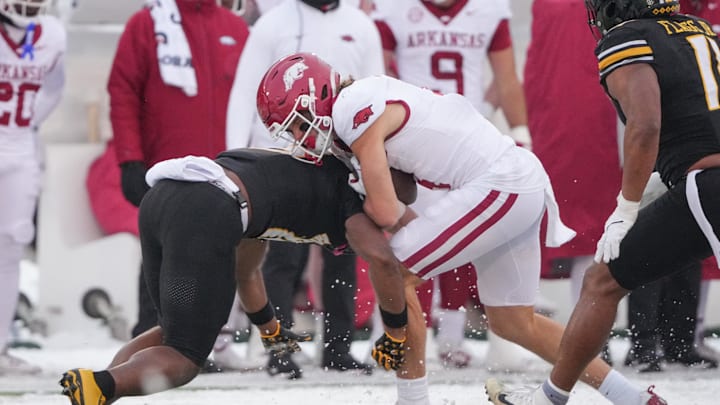 Nov 30, 2024; Columbia, Missouri, USA; Arkansas Razorbacks wide receiver Isaac TeSlaa (4) runs the hall as Missouri Tigers safety Daylan Carnell (13) makes the tackle during the first half at Faurot Field at Memorial Stadium. Mandatory Credit: Denny Medley-Imagn Images