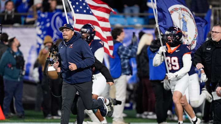 Dec 6, 2025; Charlotte, NC, USA; Virginia Cavaliers head coach Tony Elliott enters the field before the game against the Duke Blue Devils during the 2025 ACC Championship game at Bank of America Stadium. Mandatory Credit: Jim Dedmon-Imagn Images