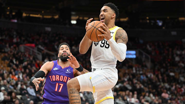 Mar 7, 2025; Toronto, Ontario, CAN;  Utah Jazz forward KJ Martin (99) drives to the basket past Toronto Raptors forward Garrett Temple (17) in the second half at Scotiabank Arena. Mandatory Credit: Dan Hamilton-Imagn Images