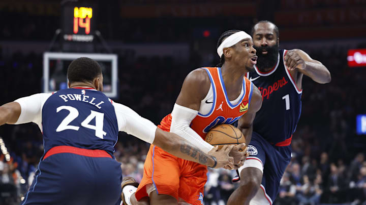 Nov 11, 2024; Oklahoma City, Oklahoma, USA; Oklahoma City Thunder guard Shai Gilgeous-Alexander (2) drives to the basket between Los Angeles Clippers guards Norman Powell (24) and James Harden (1) during the second quarter at Paycom Center. Mandatory Credit: Alonzo Adams-Imagn Images Nov 11, 2024; Oklahoma City, Oklahoma, USA; Oklahoma City Thunder guard Shai Gilgeous-Alexander (2) drives to the basket between Los Angeles Clippers guards Norman Powell (24) and James Harden (1) during the second quarter at Paycom Center. Mandatory Credit: Alonzo Adams-Imagn Images