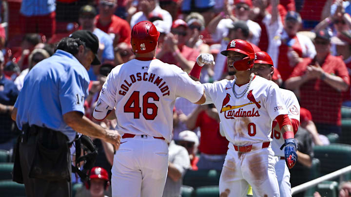 Jun 13, 2024; St. Louis, Missouri, USA;  St. Louis Cardinals first baseman Paul Goldschmidt (46) is congratulated by shortstop Masyn Winn (0) after hitting a two run home run against the Pittsburgh Pirates during the third inning at Busch Stadium. Mandatory Credit: Jeff Curry-USA TODAY Sports