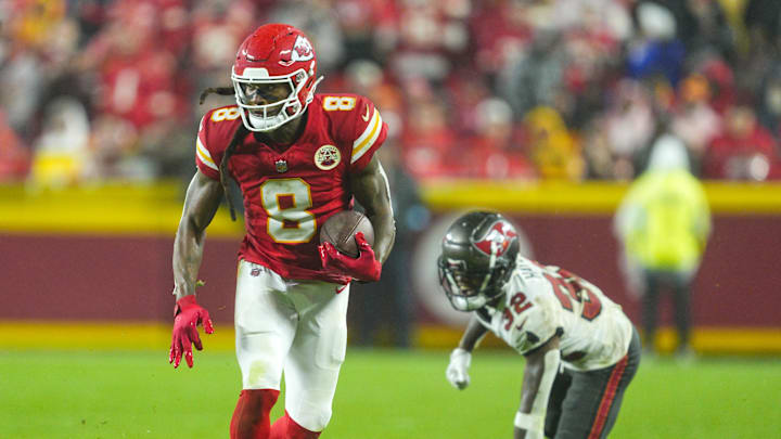 Nov 4, 2024; Kansas City, Missouri, USA; Kansas City Chiefs wide receiver DeAndre Hopkins (8) runs with the ball past Tampa Bay Buccaneers safety Josh Hayes (32) during overtime at GEHA Field at Arrowhead Stadium. Mandatory Credit: Jay Biggerstaff-Imagn Images