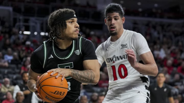 Nov 26, 2025; Cincinnati, Ohio, USA;  Eastern Michigan Eagles guard Mehki Ellison (3) dribbles the ball against Cincinnati Bearcats guard Shon Abaev (10) in the first half at Fifth Third Arena. Mandatory Credit: Aaron Doster-Imagn Images