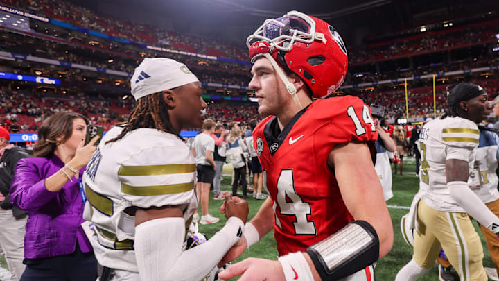 Atlanta, Georgia, USA; Georgia Bulldogs quarterback Gunner Stockton (14) talks to Georgia Tech Yellow Jackets defensive back Dalen Penson (25) after a game at Mercedes-Benz Stadium.