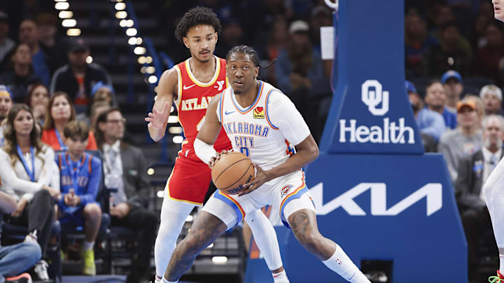Oct 17, 2024; Oklahoma City, Oklahoma, USA; Oklahoma City Thunder forward Jalen Williams (8) moves the ball around Atlanta Hawks guard Kobe Bufkin (4) during the first quarter at Paycom Center. Mandatory Credit: Alonzo Adams-Imagn Images