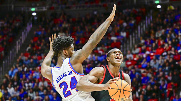 Feb 15, 2025; Salt Lake City, Utah, USA; Utah Utes forward Ezra Ausar (2) moves around Kansas Jayhawks forward KJ Adams (24) during the second half at the Jon M. Huntsman Center. Mandatory Credit: Christopher Creveling-Imagn Images