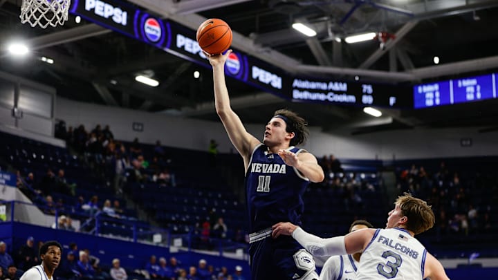 Feb 4, 2025; Colorado Springs, Colorado, USA; Nevada Wolf Pack forward Nick Davidson (11) drives to the net against Air Force Falcons forward Luke Kearney (3) in the second half at Clune Arena. Mandatory Credit: Isaiah J. Downing-Imagn Images