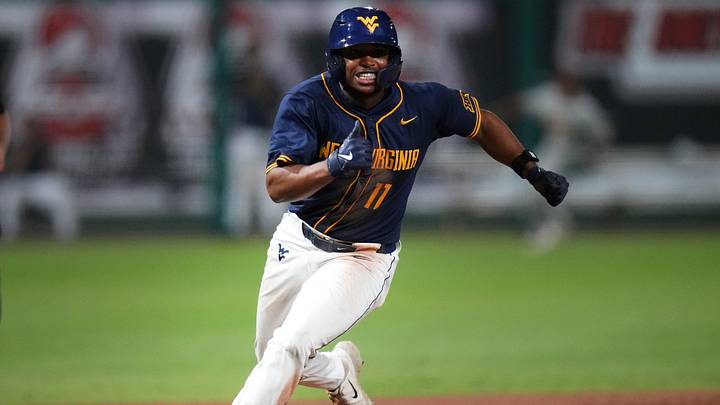 West Virginia Mountaineers base runner Sean Smith heads home to score a run against the ASU Sun Devils during their Big 12 tournament game at Surprise Stadium on May 22, 2026. West Virginia Mountaineers base runner Sean Smith heads home to score a run against the ASU Sun Devils during their Big 12 tournament game at Surprise Stadium on May 22, 2026.