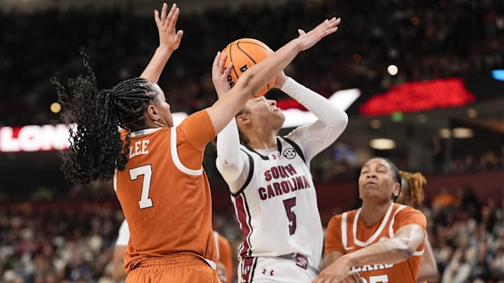Mar 9, 2025; Greenville, SC, USA; South Carolina Gamecocks guard Tessa Johnson (5) surrounded by Texas Longhorns guard Jordan Lee (7) and forward Madison Booker (35) during the second half at Bon Secours Wellness Arena. Mandatory Credit: Jim Dedmon-Imagn Images
