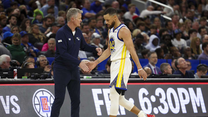 Mar 27, 2024; Orlando, Florida, USA;  Golden State Warriors head coach Steve Kerr substitutes  guard Stephen Curry (30) against the Orlando Magic in the fourth quarter at the Kia Center. Mandatory Credit: Nathan Ray Seebeck-Imagn Images