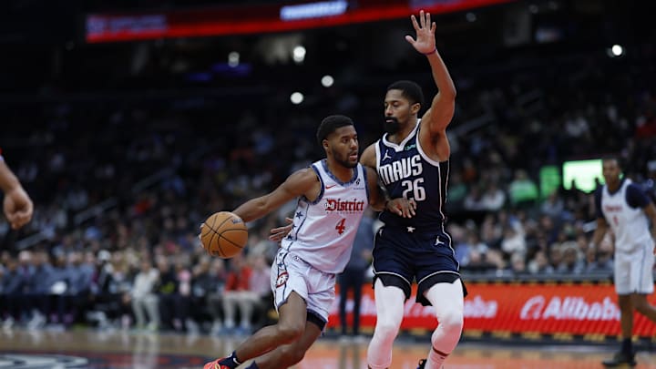 Dec 5, 2024; Washington, District of Columbia, USA; Washington Wizards guard Jared Butler (4) drives to the basket as Dallas Mavericks guard Spencer Dinwiddie (26) defends in the third quarter at Capital One Arena. Mandatory Credit: Geoff Burke-Imagn Images