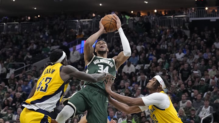 Apr 25, 2025; Milwaukee, Wisconsin, USA; Milwaukee Bucks forward Giannis Antetokounmpo (34) puts up a shot against Indiana Pacers forward Pascal Siakam (43) and Indiana Pacers center Myles Turner (33) in the second half during game three of first round for the 2024 NBA Playoffs at Fiserv Forum. Mandatory Credit: Michael McLoone-Imagn Images